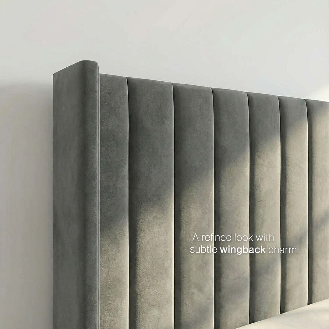 Close-up of the Milan wingback bed headboard showing the vertical channelling and curved wing