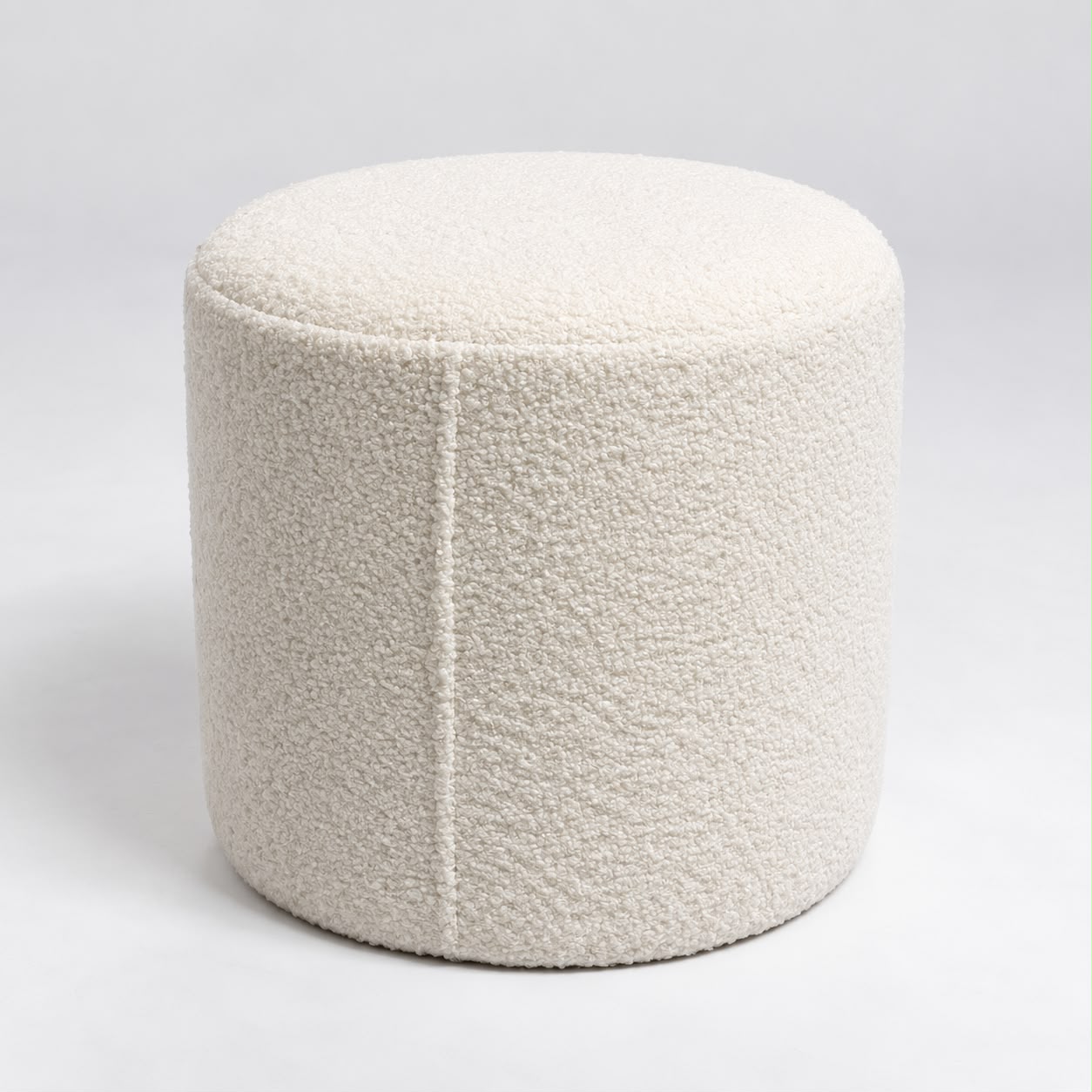 Close view of the Arlo stool showing the looped cream bouclé fabric and the single vertical seam